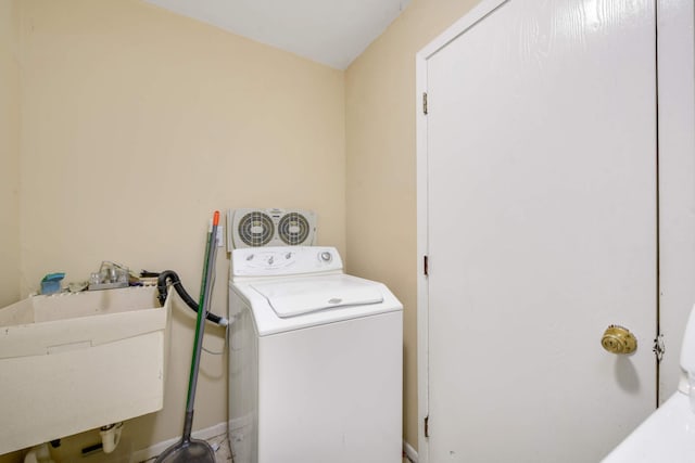 clothes washing area featuring washer / dryer and sink