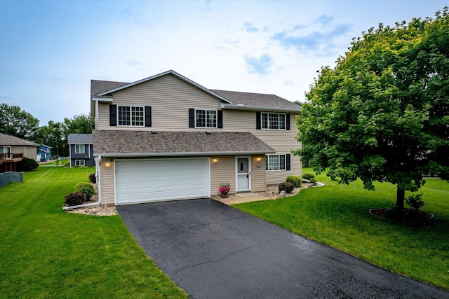 view of front of home featuring a garage and a front lawn