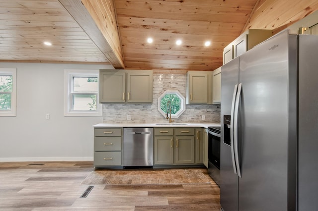 kitchen with sink, stainless steel appliances, light hardwood / wood-style floors, and wooden ceiling