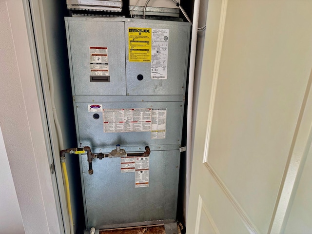 utility room featuring heating unit