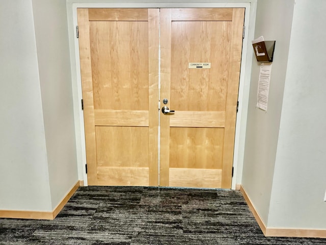 interior space featuring baseboards and wood finished floors
