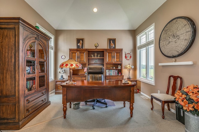 carpeted office featuring vaulted ceiling