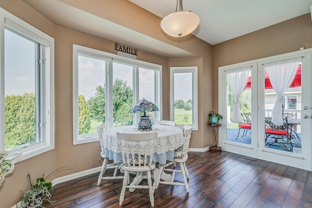 dining area featuring dark wood-type flooring and a wealth of natural light