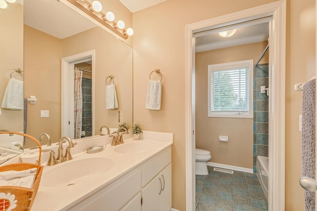 full bathroom featuring a textured ceiling, shower / tub combo with curtain, vanity, and toilet