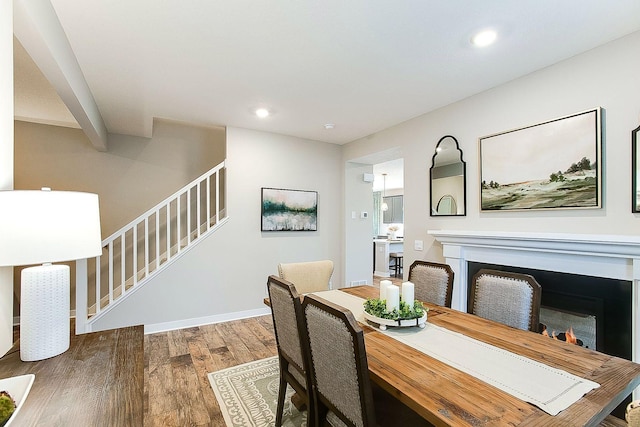 dining space with dark hardwood / wood-style flooring