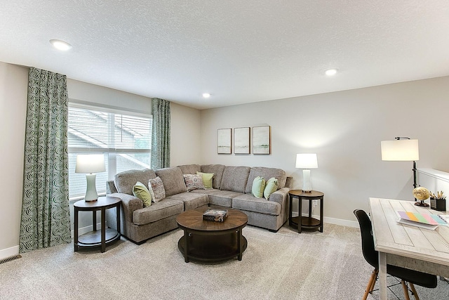 living room with light colored carpet and a textured ceiling