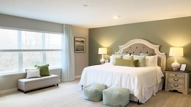 carpeted bedroom with multiple windows and a textured ceiling