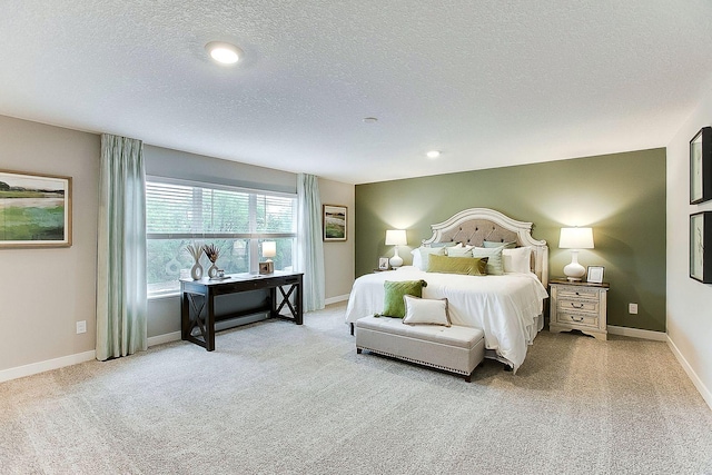 bedroom with light carpet and a textured ceiling