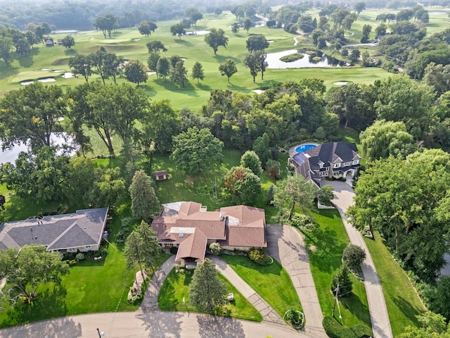 drone / aerial view with view of golf course and a water view