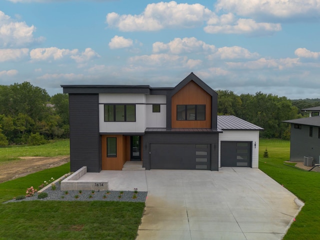 modern home featuring a front lawn and a garage