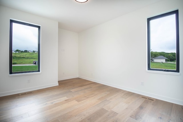 unfurnished room featuring light hardwood / wood-style floors