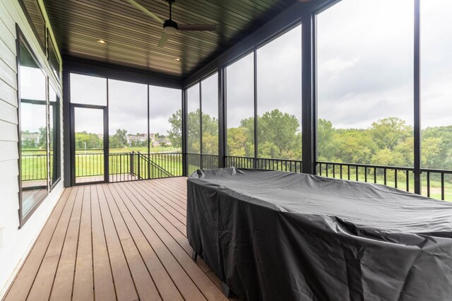 unfurnished sunroom with wooden ceiling, a wealth of natural light, and ceiling fan