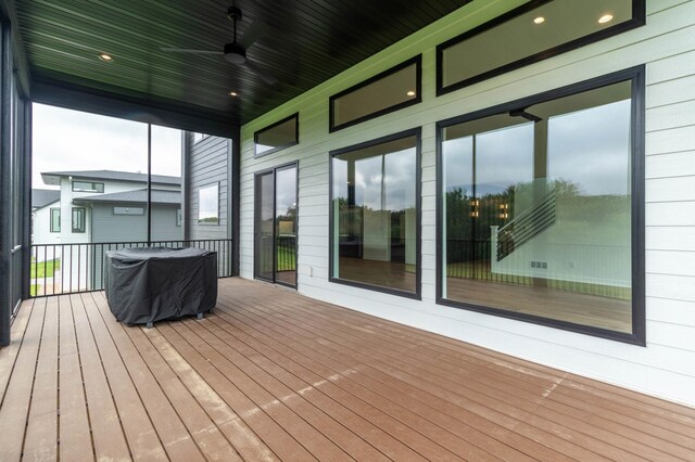 wooden terrace featuring ceiling fan