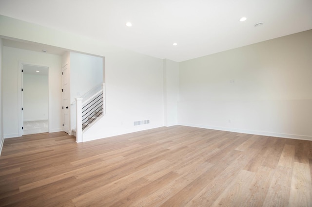 empty room with light hardwood / wood-style flooring