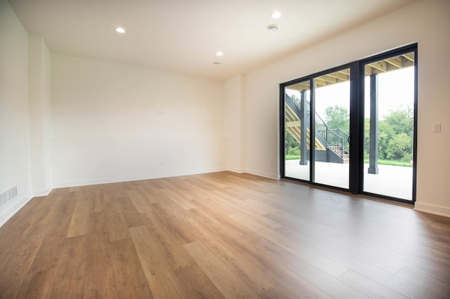 unfurnished room with wood-type flooring