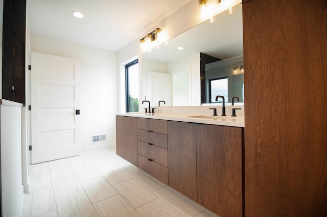 bathroom with tile patterned flooring and double sink vanity