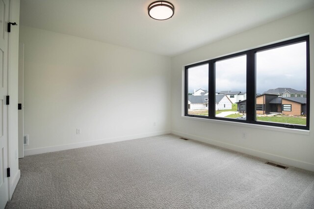 empty room with light colored carpet