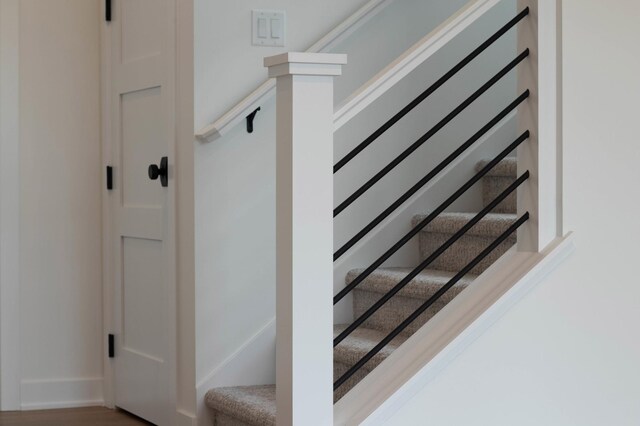 stairs featuring hardwood / wood-style floors