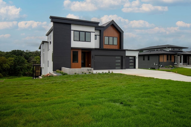 contemporary house featuring a garage and a front yard