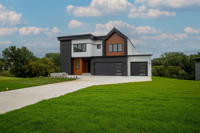 contemporary home featuring a garage and a front yard