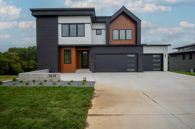 contemporary house with a garage and a front yard