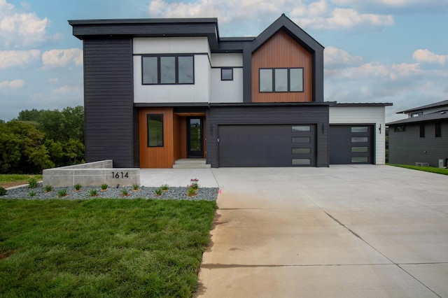 modern home featuring a front lawn and a garage