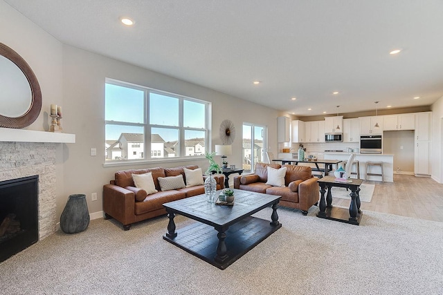 living room with light hardwood / wood-style flooring and a fireplace