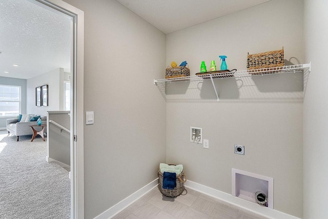 laundry area with washer hookup, carpet flooring, hookup for an electric dryer, and a textured ceiling