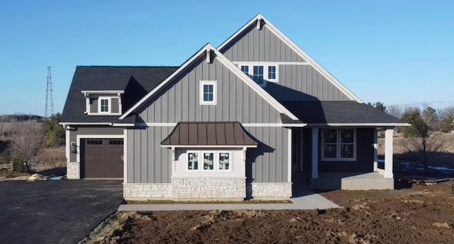 view of front of property featuring a garage and covered porch