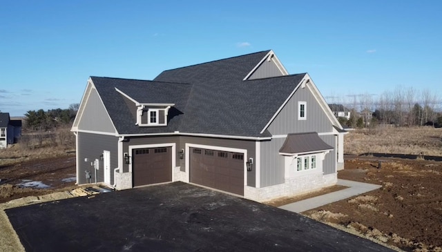 view of side of home featuring a garage