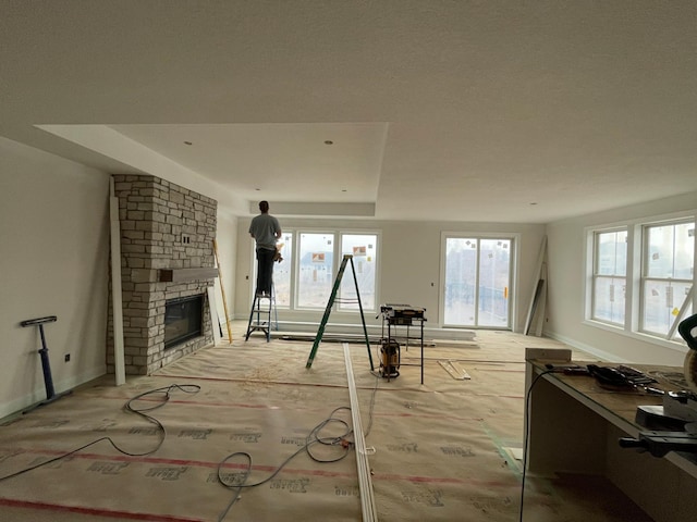 living room with plenty of natural light and a large fireplace