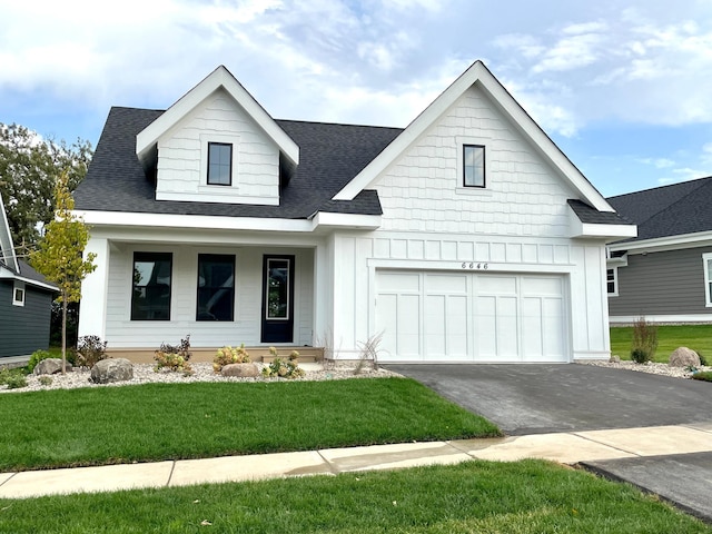 view of front of property with a garage and a front lawn