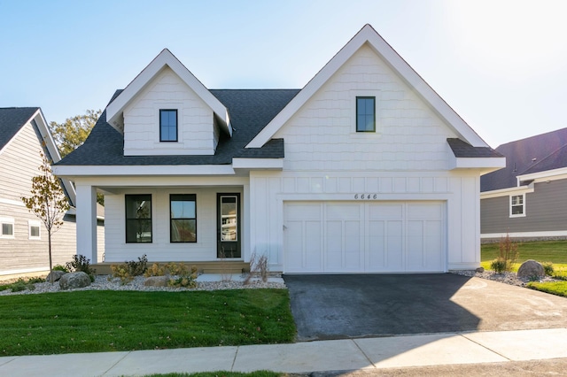 view of front of house with a front yard and a garage