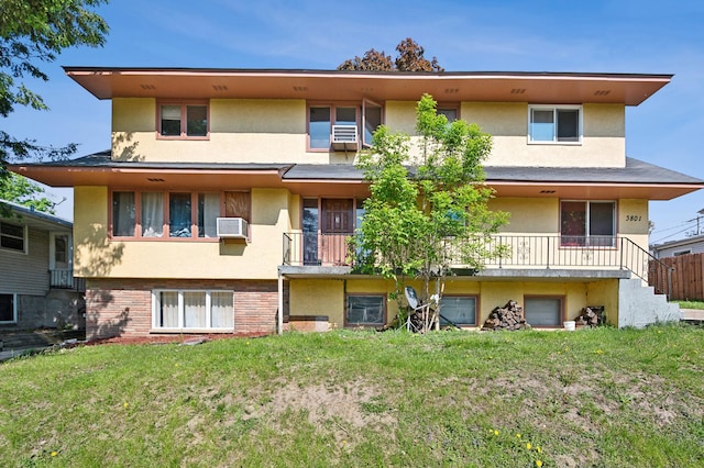 back of house with a lawn and an AC wall unit