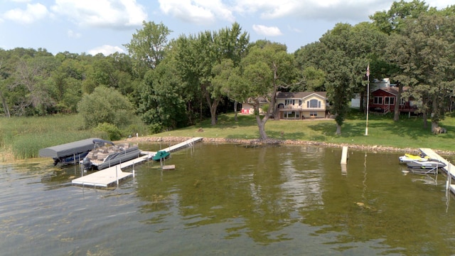 dock area with a lawn and a water view