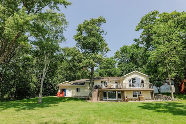 back of property featuring a deck and a yard