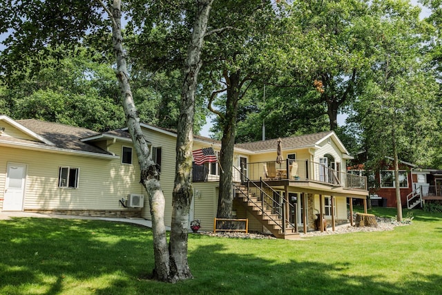 back of property featuring a wooden deck and a yard