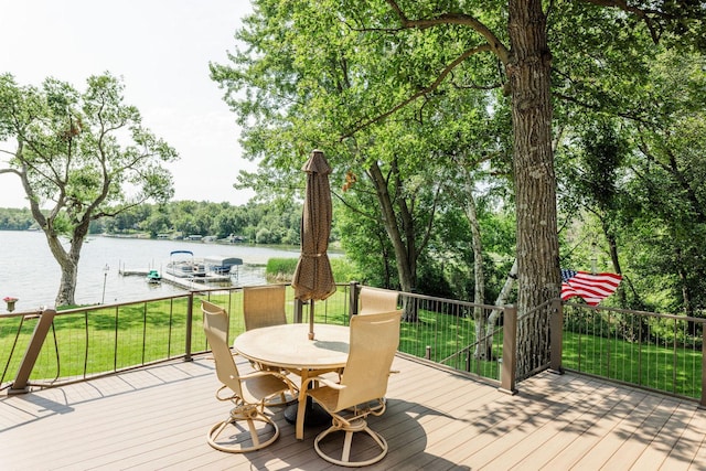 wooden terrace with a lawn and a water view