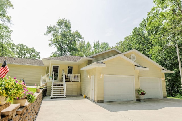 ranch-style home with a porch and a garage