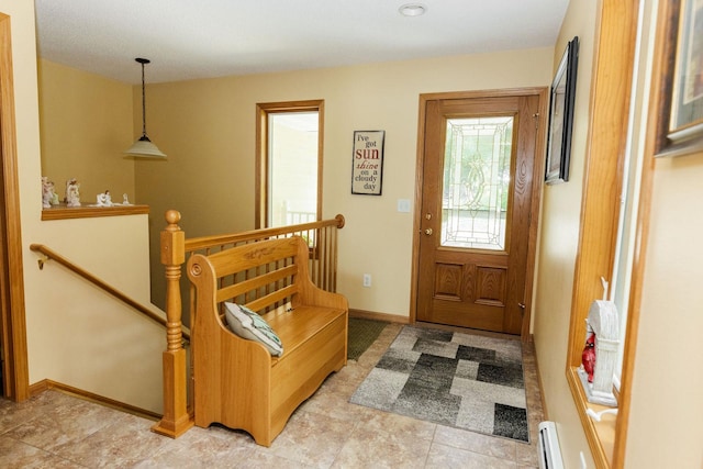 entryway featuring light tile patterned floors and a baseboard heating unit