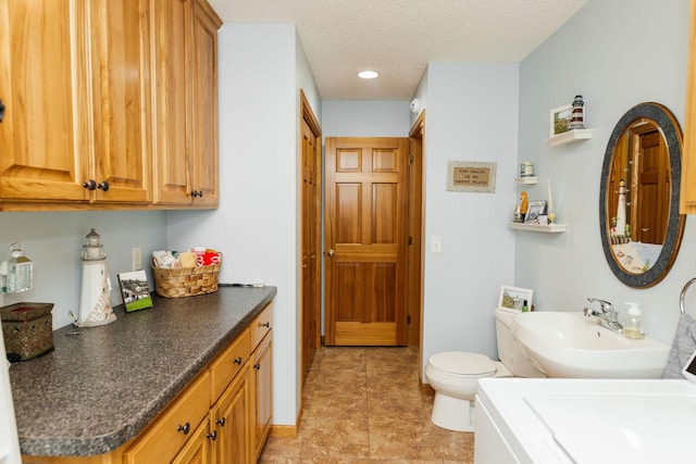 bathroom featuring a textured ceiling, tile patterned flooring, vanity, and toilet