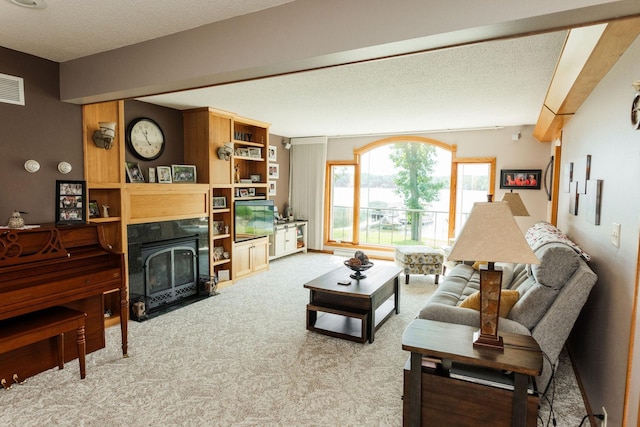 carpeted living room featuring a textured ceiling