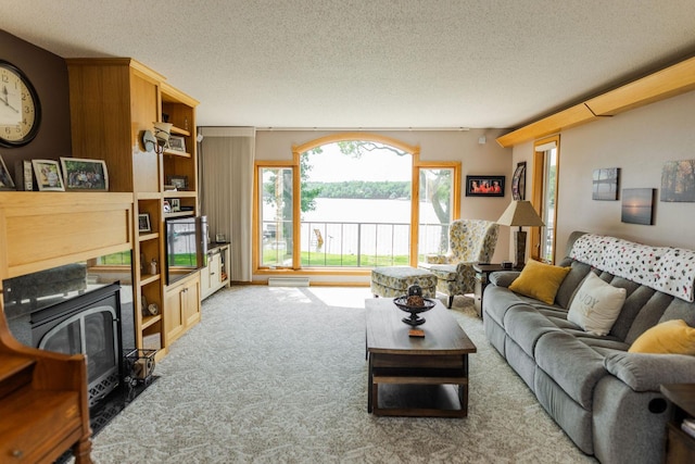 carpeted living room featuring a textured ceiling