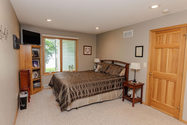 carpeted bedroom featuring a textured ceiling