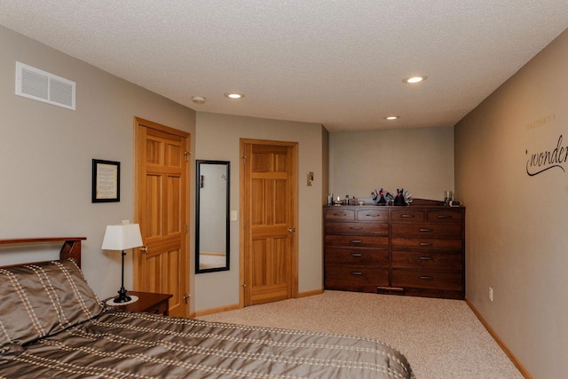 carpeted bedroom with a textured ceiling