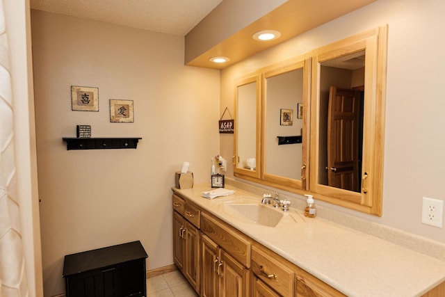 bathroom with vanity, tile patterned flooring, and a textured ceiling