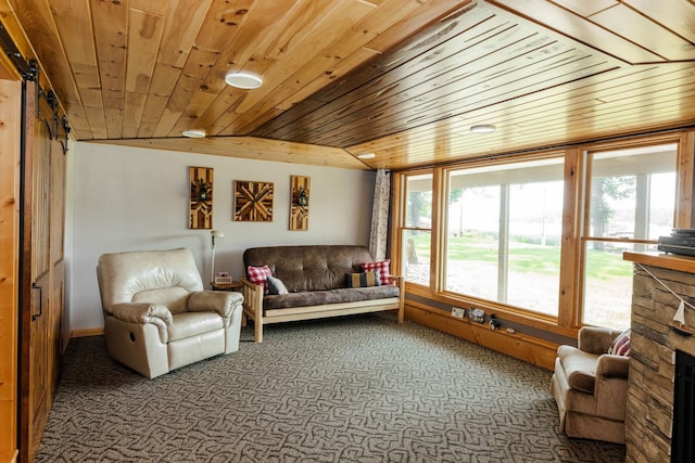 interior space with carpet flooring, wood ceiling, a fireplace, and lofted ceiling