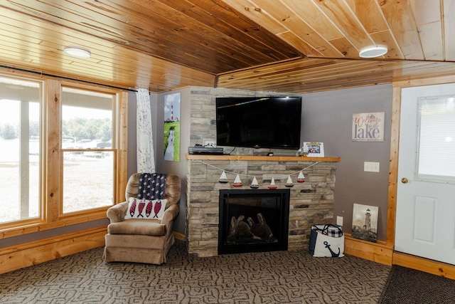 living room featuring a wealth of natural light, lofted ceiling, wooden ceiling, and a fireplace