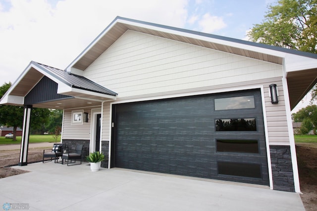 501 1st St NE, Hankinson, ND 58041 - view of side of home with stone siding, driveway, and a garage