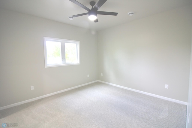 501 1st St NE, Hankinson, ND 58041 - empty room with light colored carpet, baseboards, and a ceiling fan